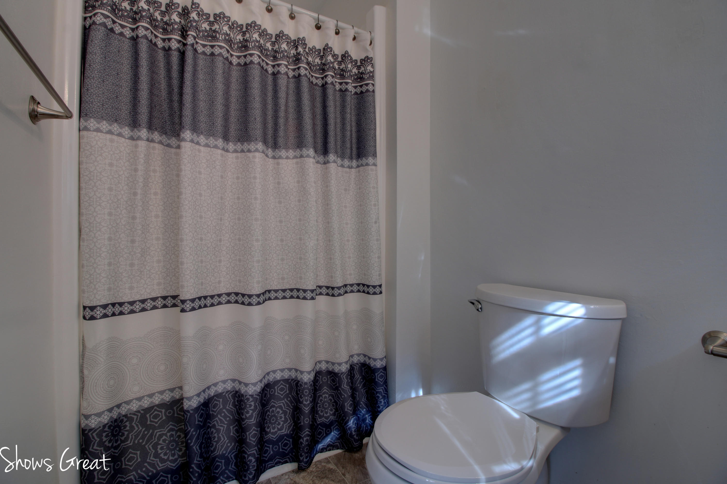 36 Spruce Lane Blue Ridge, VA 24064 - Photo 27 of 35 a bathroom with a toilet and a shower curtain