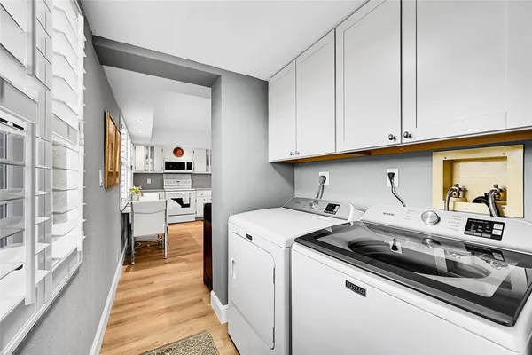 a kitchen with stainless steel appliances a refrigerator sink and white cabinets