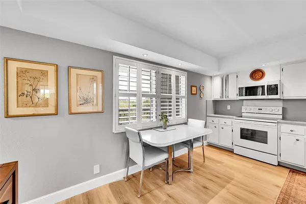 a kitchen with stainless steel appliances a refrigerator sink and wooden cabinets