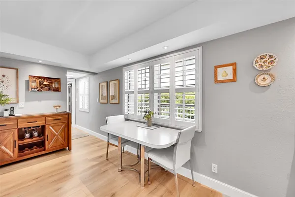 a view of a hallway with wooden floor and closet