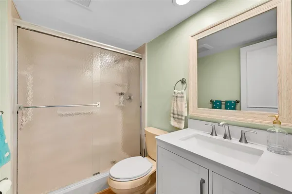 a bedroom with a bed and a lamp with the wooden floor