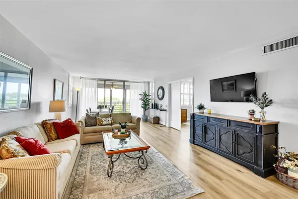 a view of a dining room with furniture and wooden floor