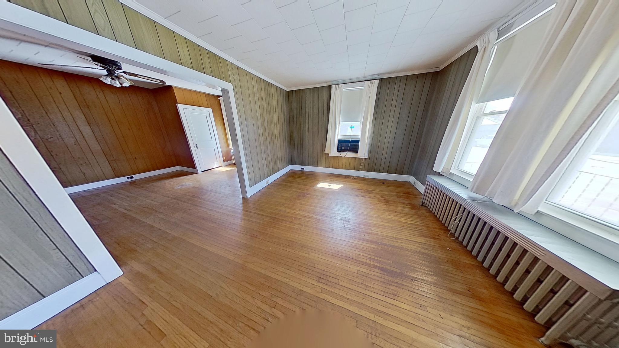 1301 North Duke Street York, PA 17404 - Photo 4 of 8 a view of an empty room with wooden floor and a window