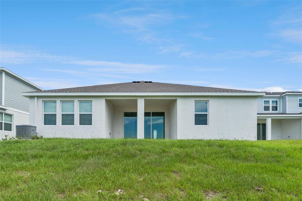 1672 Rider Rain Lane Apopka, FL 32703 - Photo 32 of 35 a view of a house with a backyard