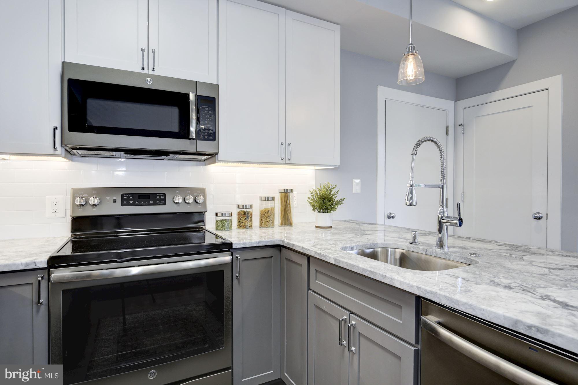 1340 Nicholson Street Northwest, Unit 4 Washington, DC 20011 - Photo 2 of 16 Two tone shaker cabinetry, USB Outlets, Disposal