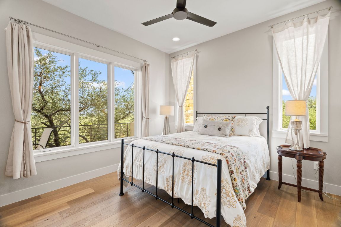 11400 Crumley Ranch Road Austin, TX 78738 - Photo 25 of 39 a bedroom with a bed and a table