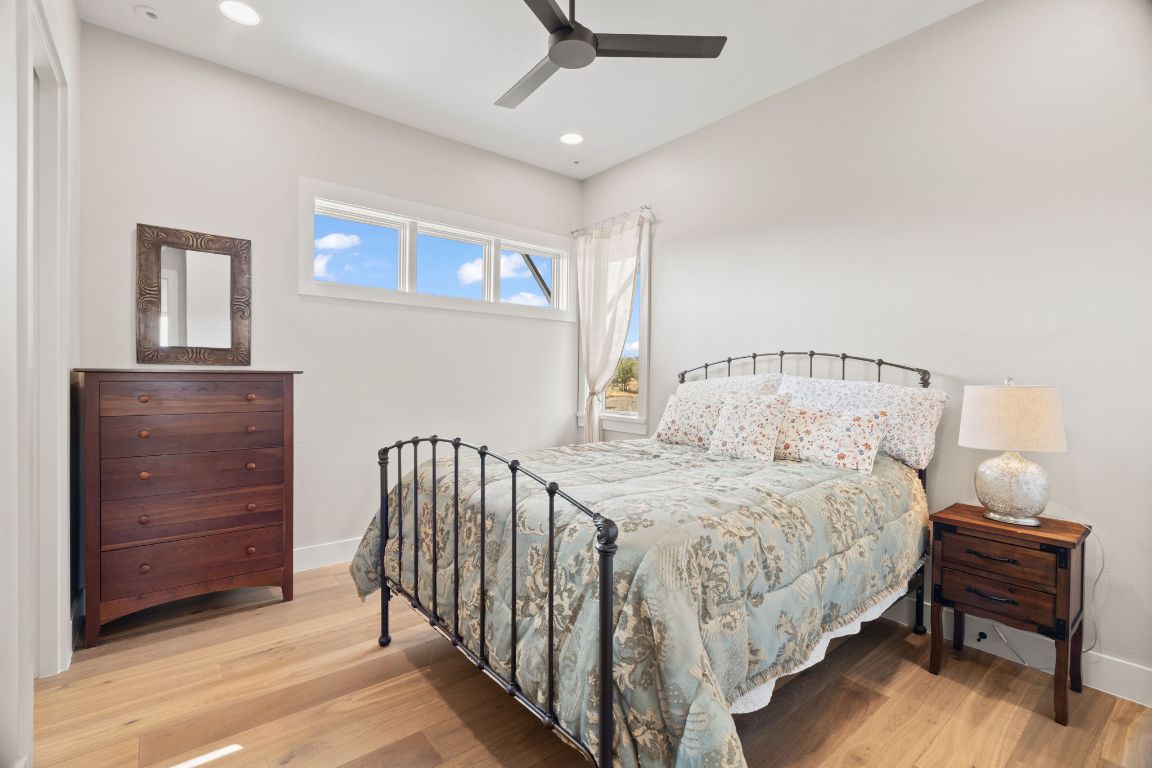 11400 Crumley Ranch Road Austin, TX 78738 - Photo 28 of 39 a bedroom with a bed and a dresser