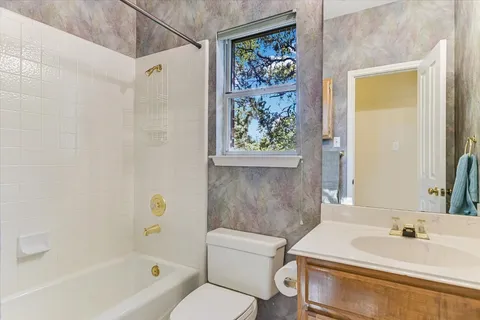 a bathroom with a sink a toilet and bathtub