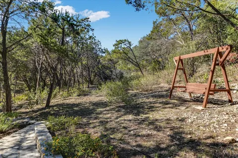 a backyard of a house with table and chairs