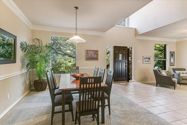 a view of a dining room with furniture and window