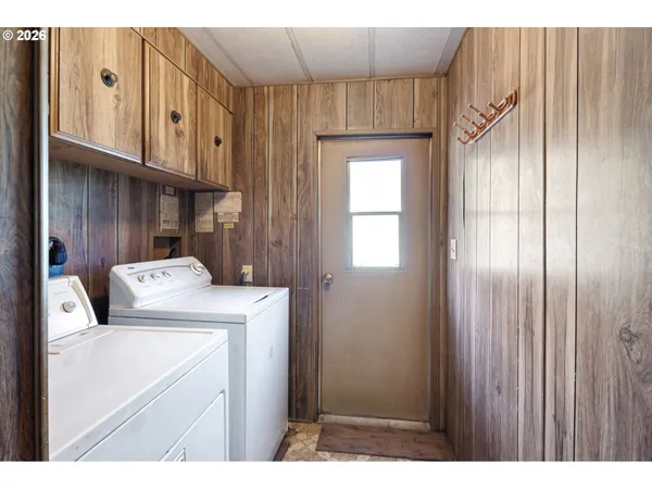 a view of a hallway with wooden shelves