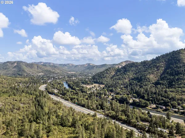 a backyard of a house with a yard and outdoor seating