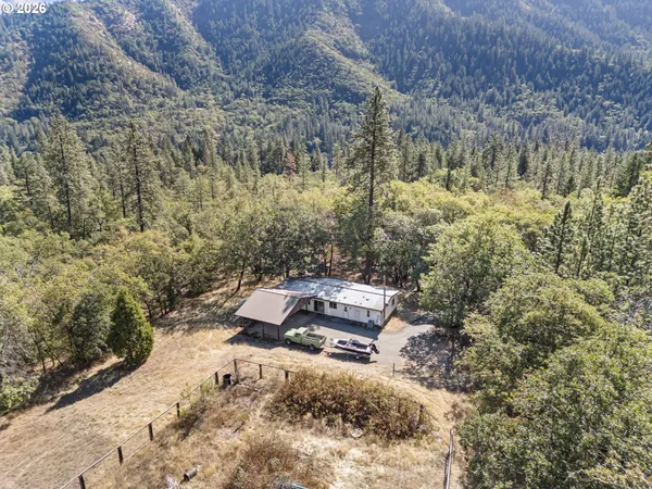 a view of house with backyard and seating space