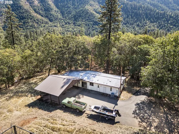 an aerial view of a house with a yard