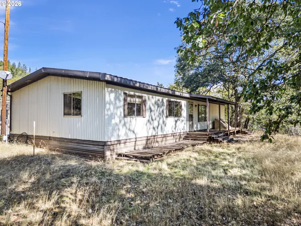 a view of a house with backyard and sitting area