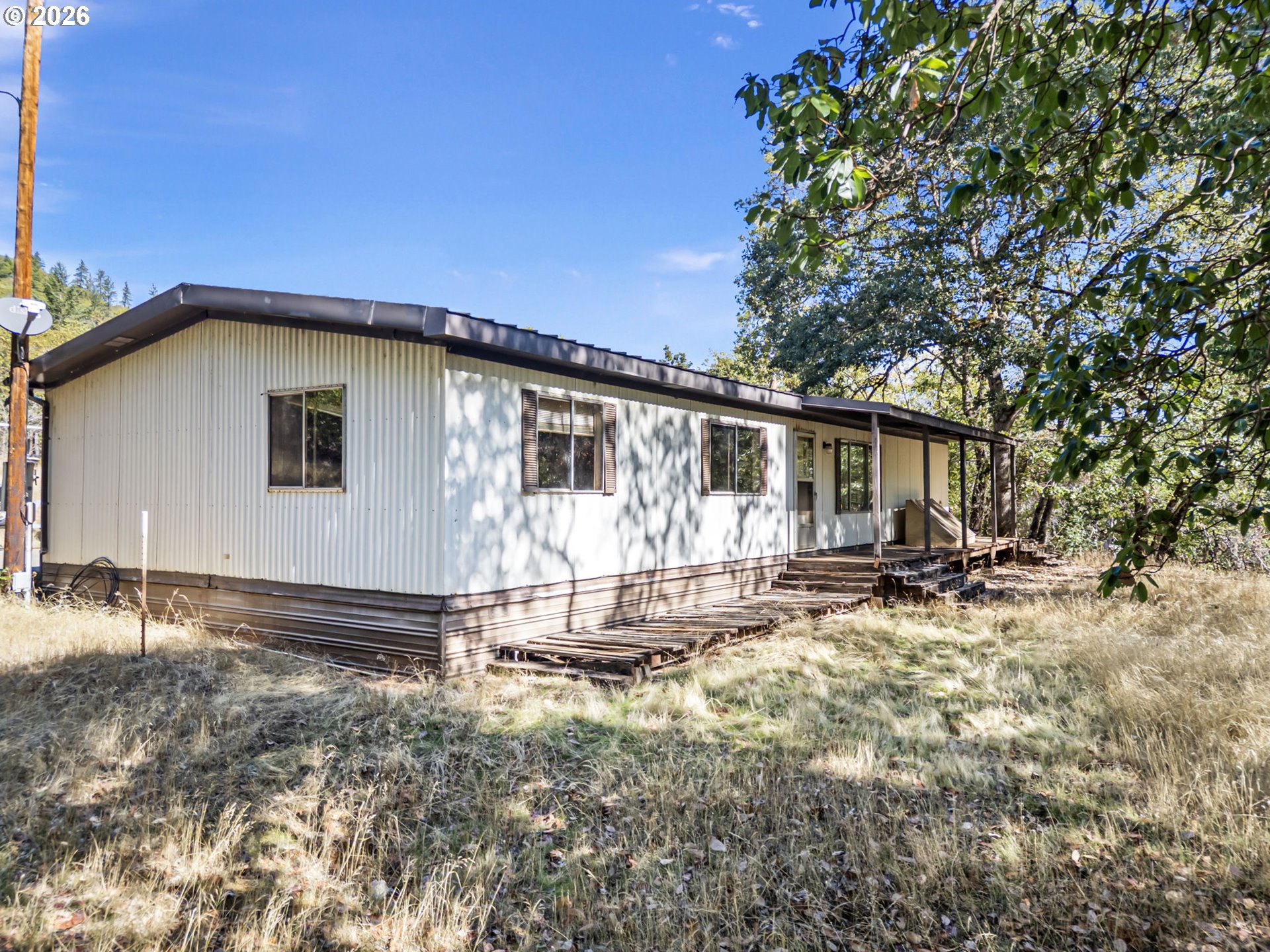 4950 Foothill Boulevard Grants Pass, OR 97526 - Photo 4 of 43 a view of a house with backyard and sitting area