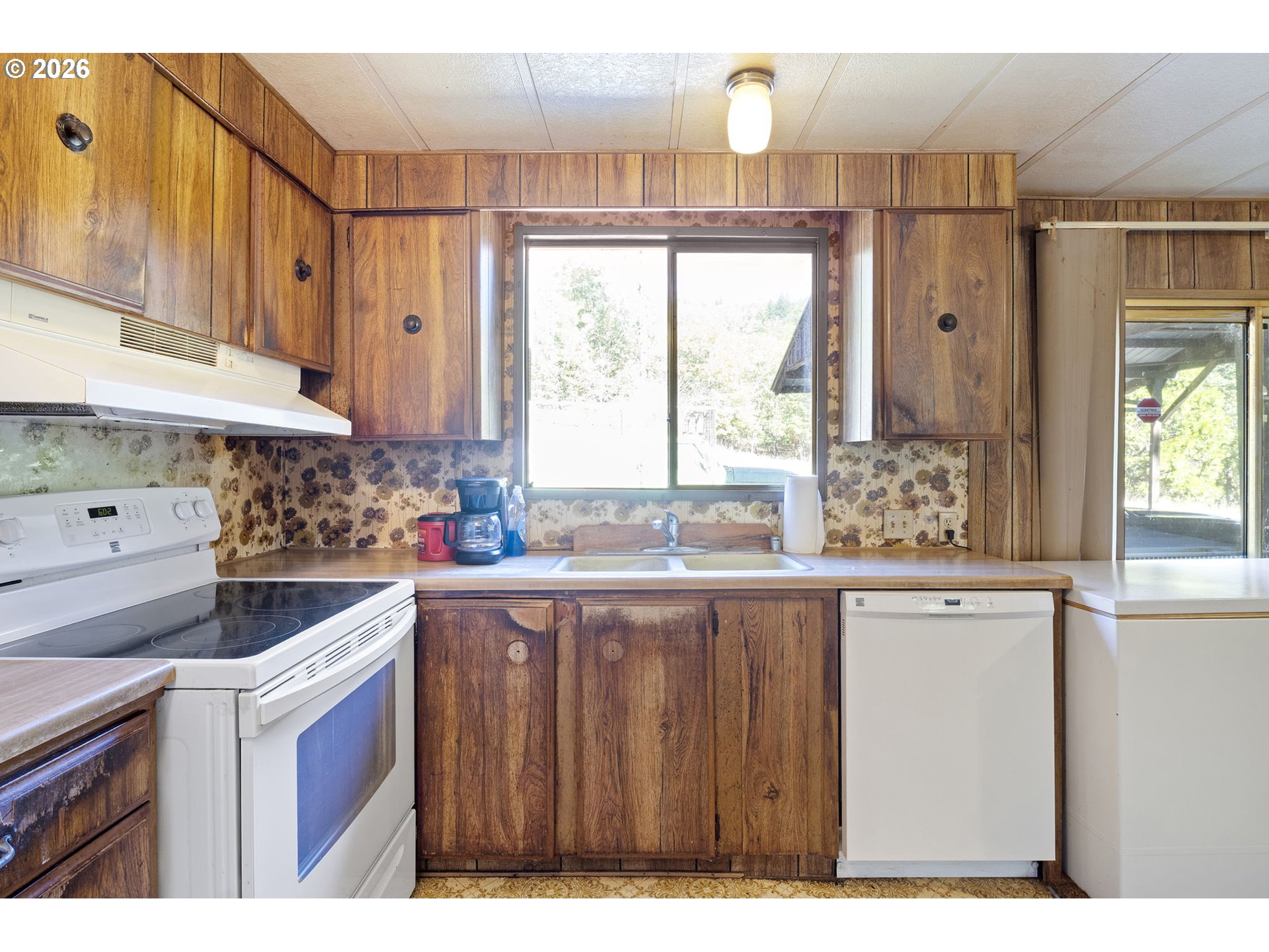4950 Foothill Boulevard Grants Pass, OR 97526 - Photo 9 of 43 a kitchen with a sink a window and stainless steel appliances