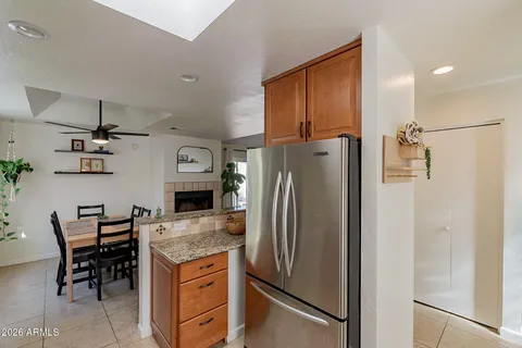 a kitchen with stainless steel appliances granite countertop a refrigerator and a stove top oven