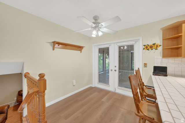 1464 990 West Provo, UT 84601 - Photo 17 of 41 Room featuring wood-finish flooring, a ceiling fan, and white French doors