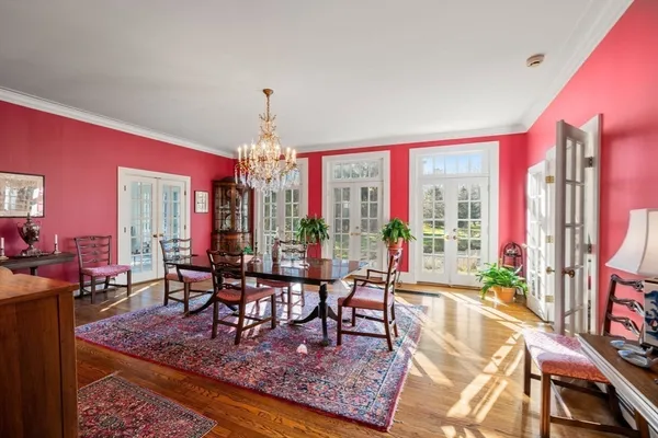 a living room with furniture a lamp a rug and a chandelier