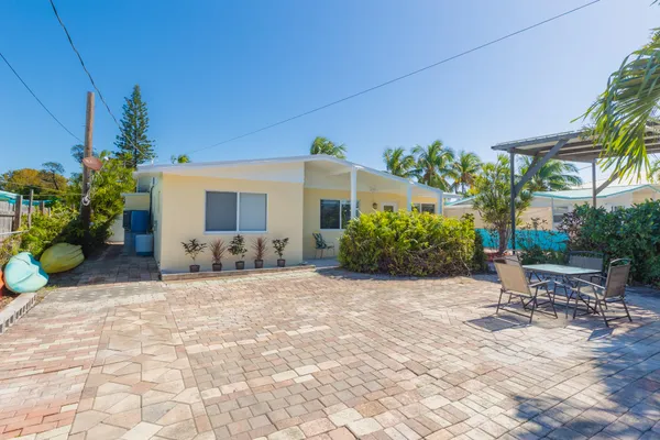 a view of a chair and table in backyard