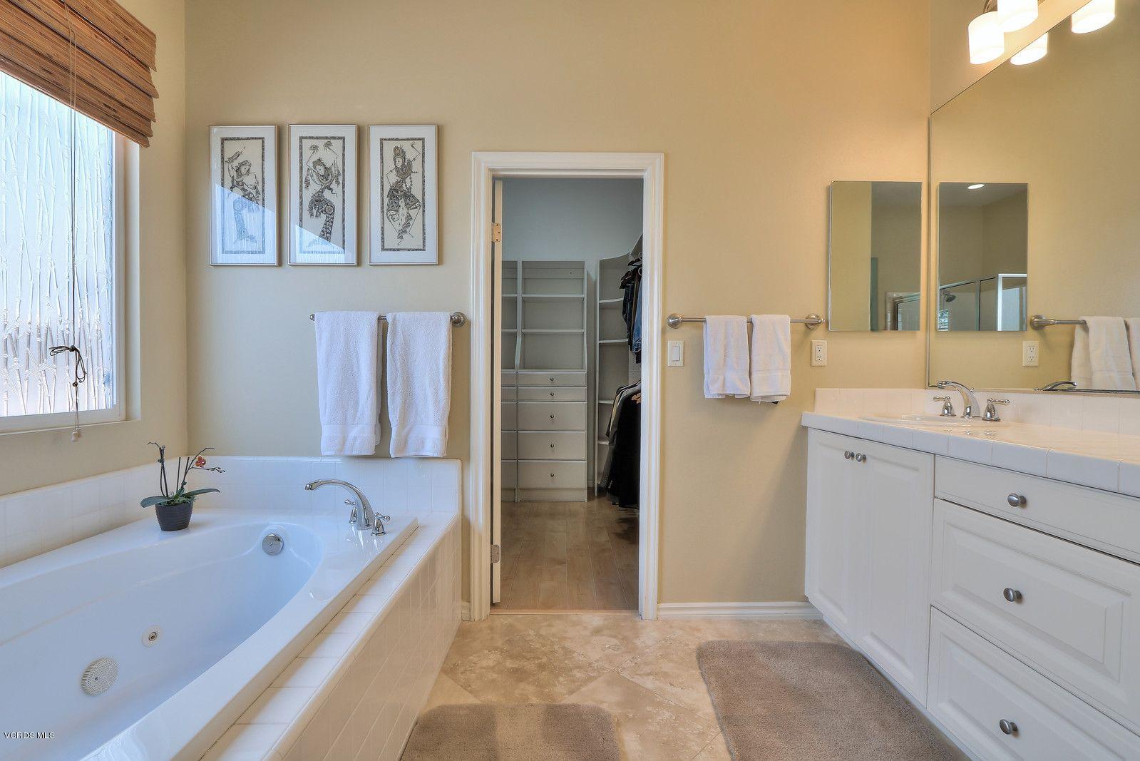 2011 Turnberry Drive Oxnard, CA 93036 - Photo 22 of 56 a bathroom with a tub sink and mirror