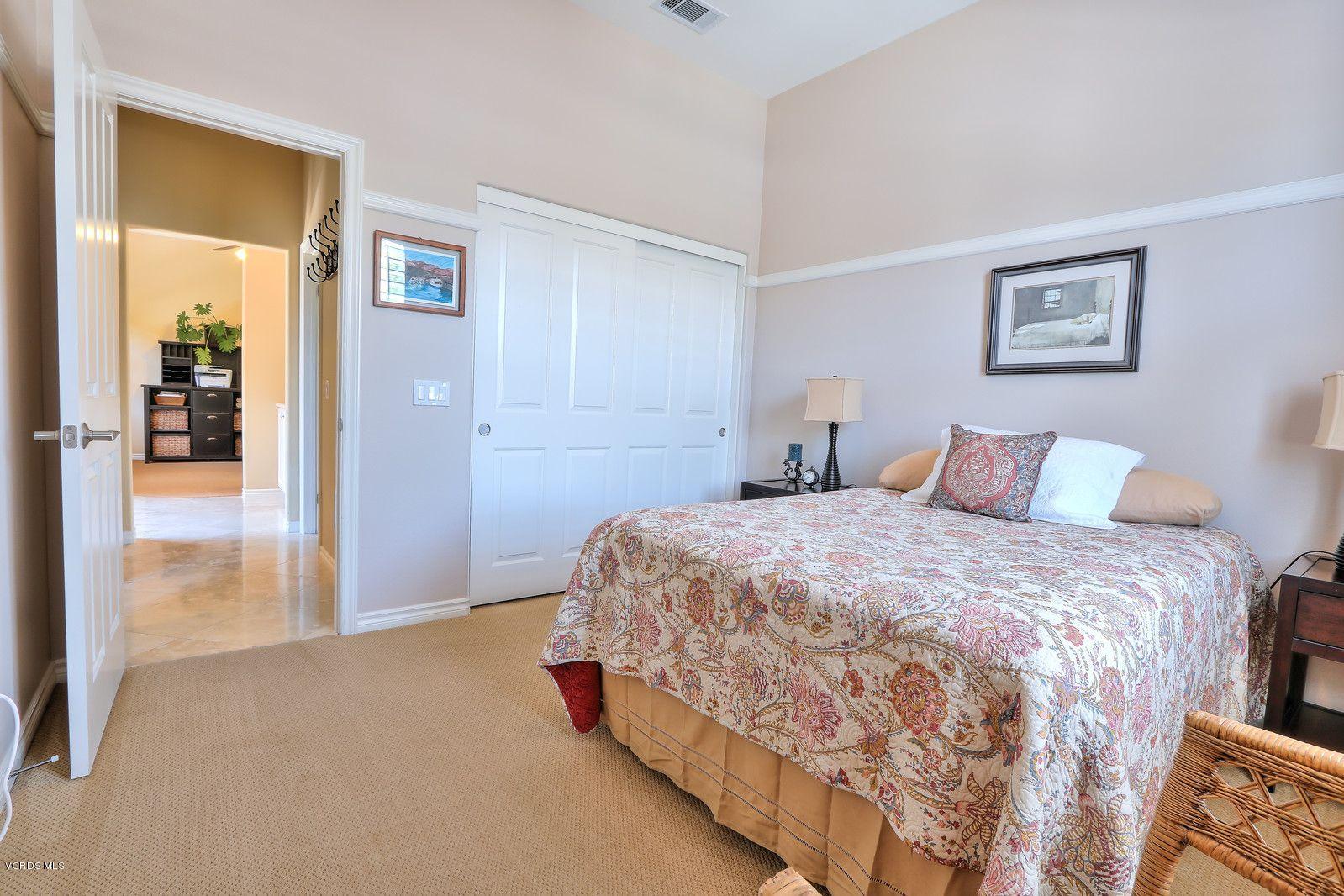 2011 Turnberry Drive Oxnard, CA 93036 - Photo 28 of 56 a bedroom with a bed and glass door