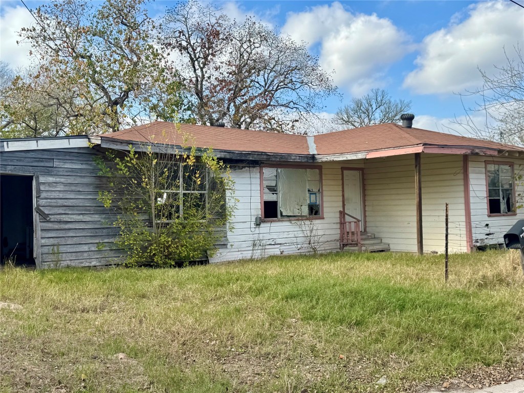 117 Charles Street Cuero, TX 77954 - Photo 4 of 13 a view of a house with a yard and sitting area