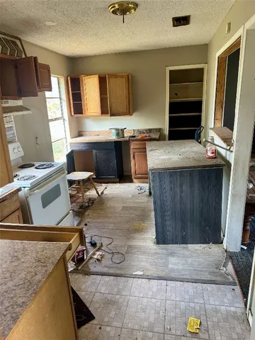 a kitchen with a sink a stove and cabinets