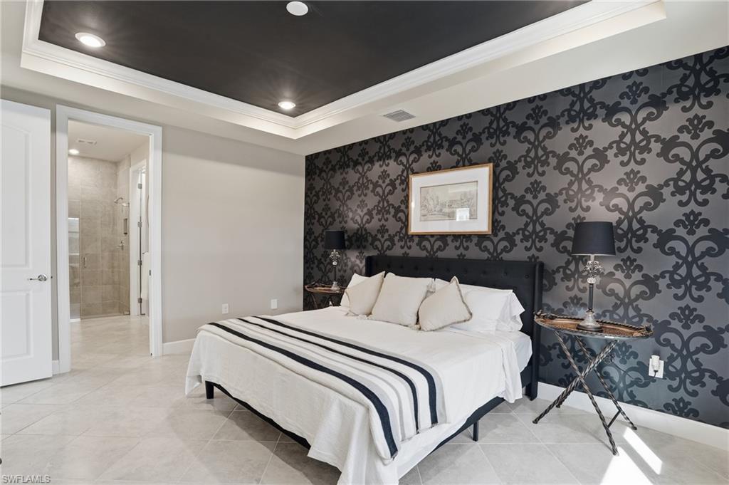 20143 Torch Key Way Estero, FL 33928 - Photo 11 of 26 a bedroom with bed and a night stand
