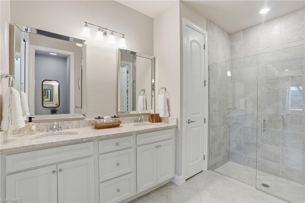 20143 Torch Key Way Estero, FL 33928 - Photo 12 of 26 a bathroom with double sink and a mirror