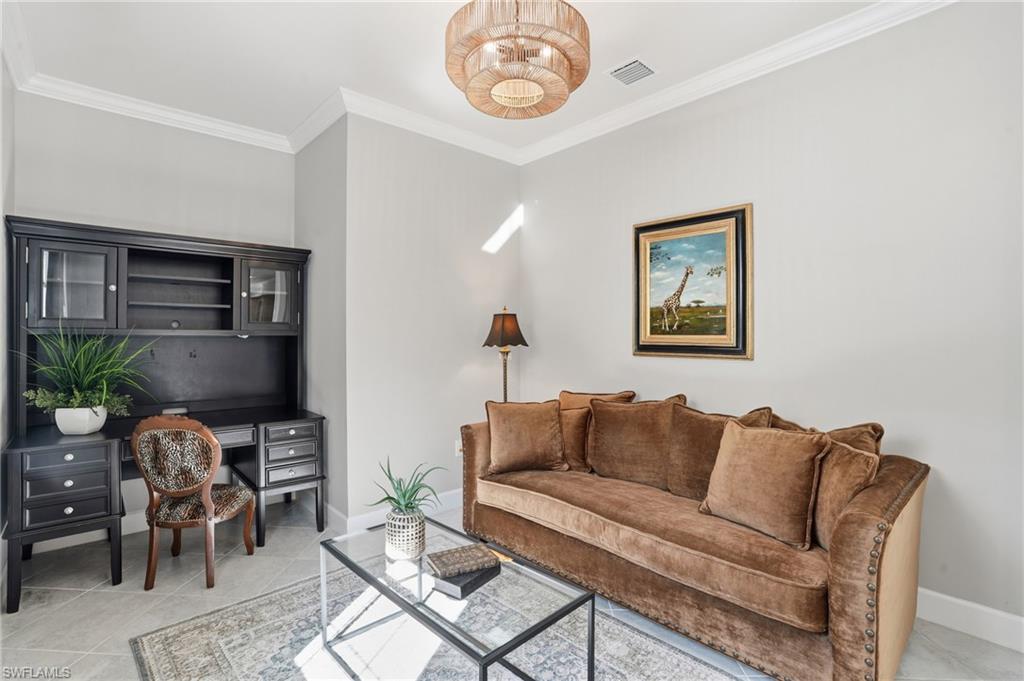 20143 Torch Key Way Estero, FL 33928 - Photo 13 of 26 a living room with furniture a rug and a wall painting