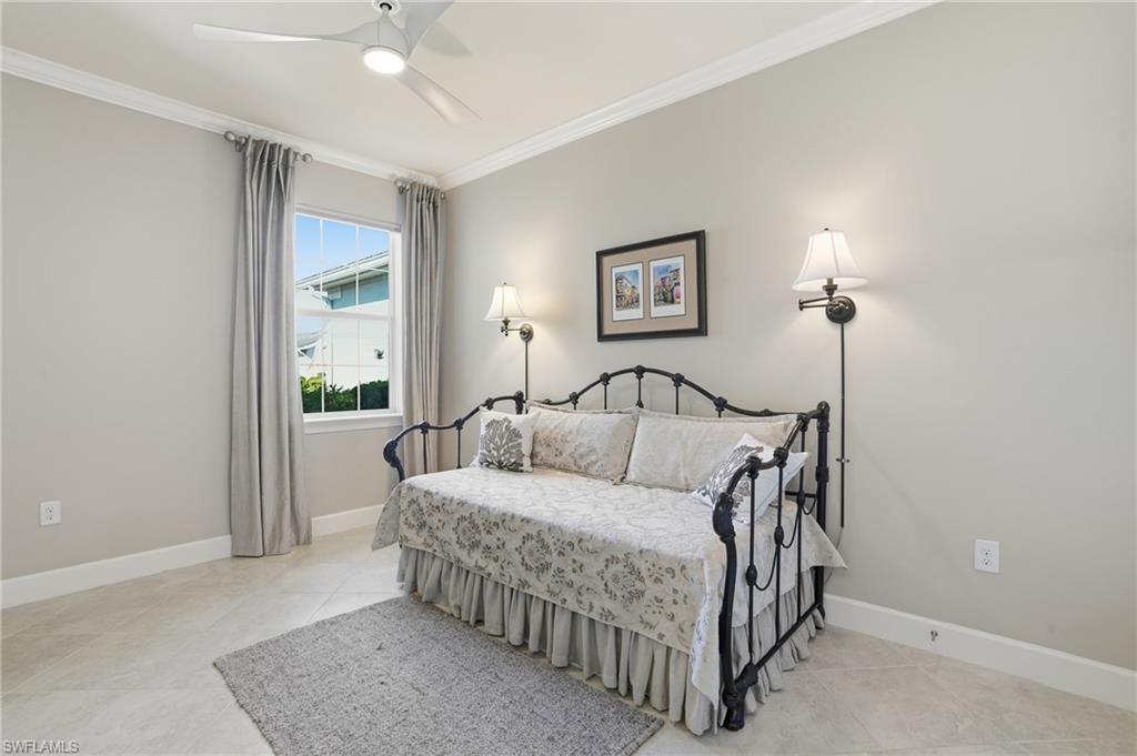 20143 Torch Key Way Estero, FL 33928 - Photo 15 of 26 a bedroom with a bed lamp and a window