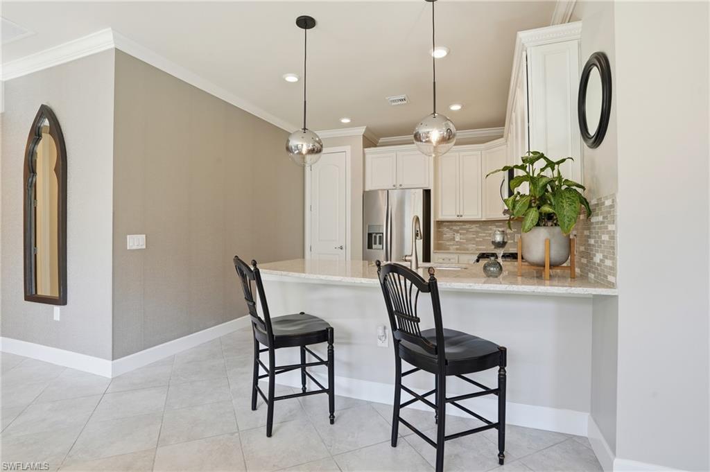 20143 Torch Key Way Estero, FL 33928 - Photo 18 of 26 a dining room with furniture and window