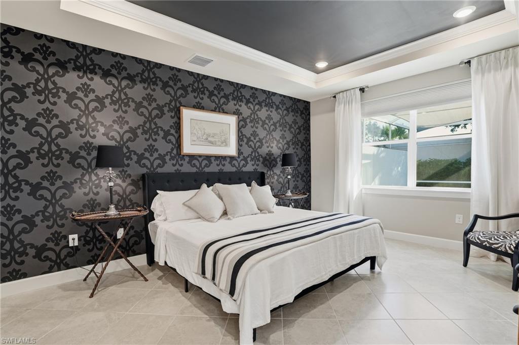 20143 Torch Key Way Estero, FL 33928 - Photo 10 of 26 a bedroom with a bed a chair and next to a window