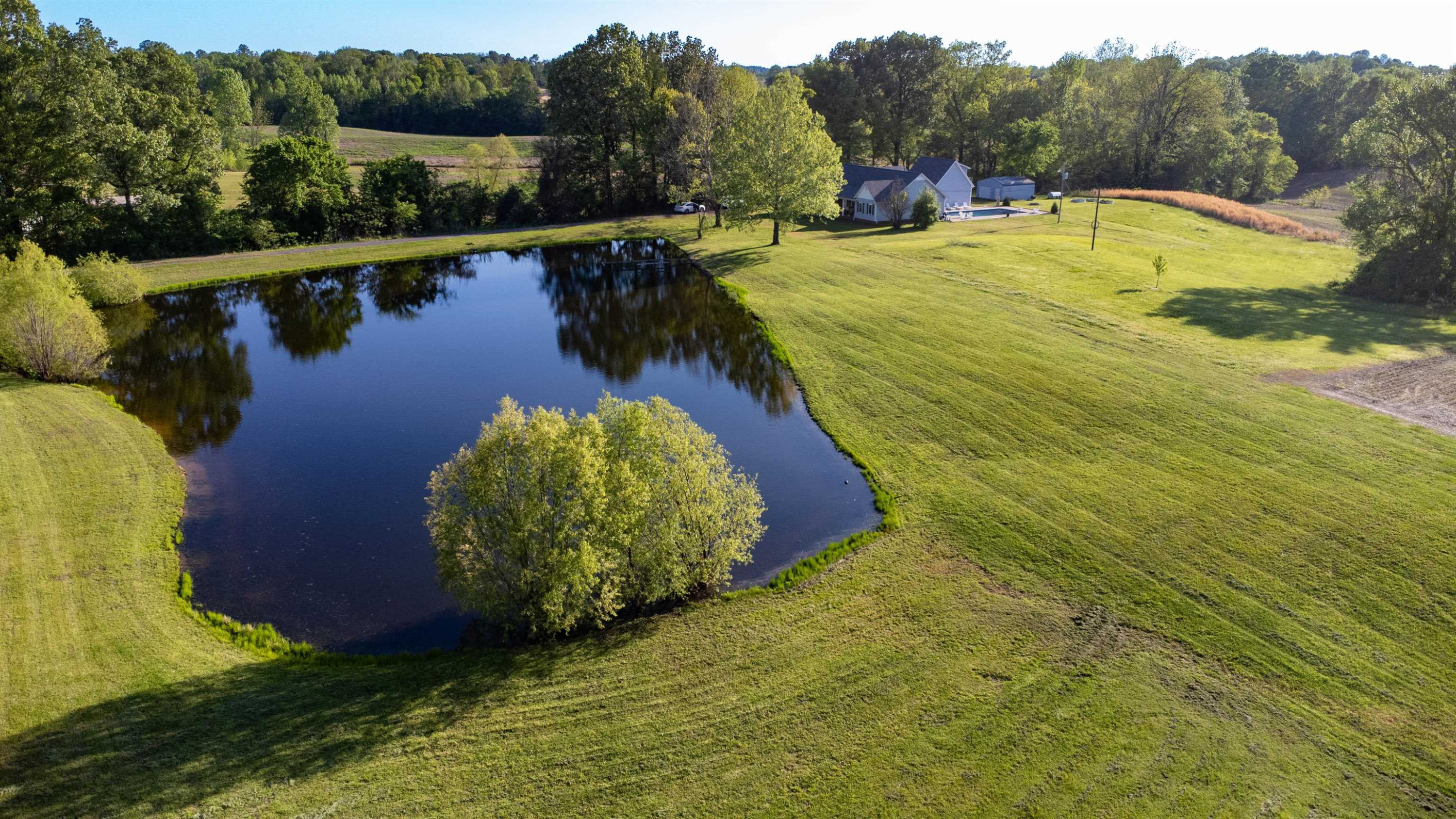 495 Junius Lee Road Ripley, TN 38063 - Photo 1 of 38 a view of a lake with a yard