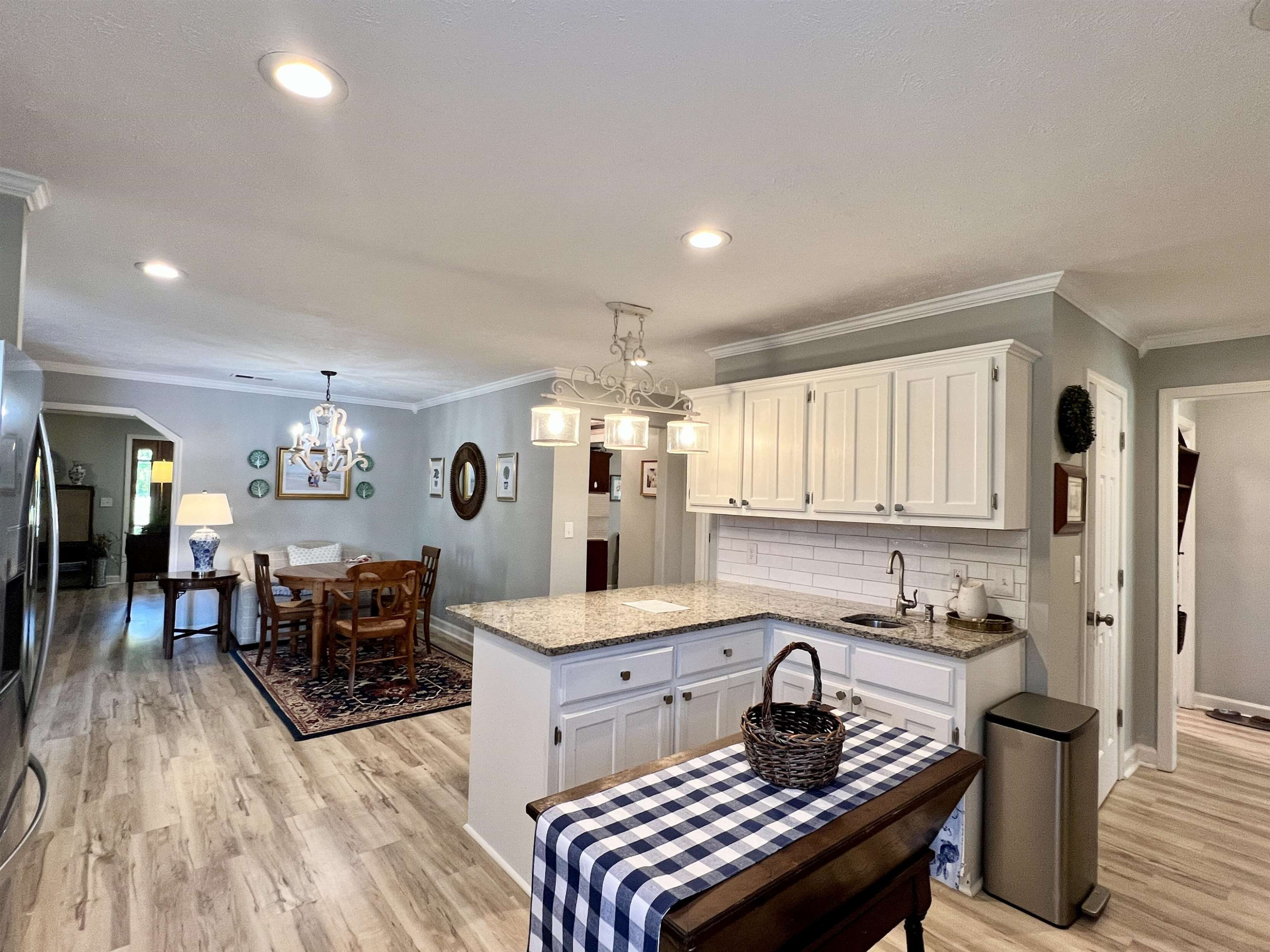 495 Junius Lee Road Ripley, TN 38063 - Photo 17 of 38 a kitchen with a dining table chairs and granite counter tops