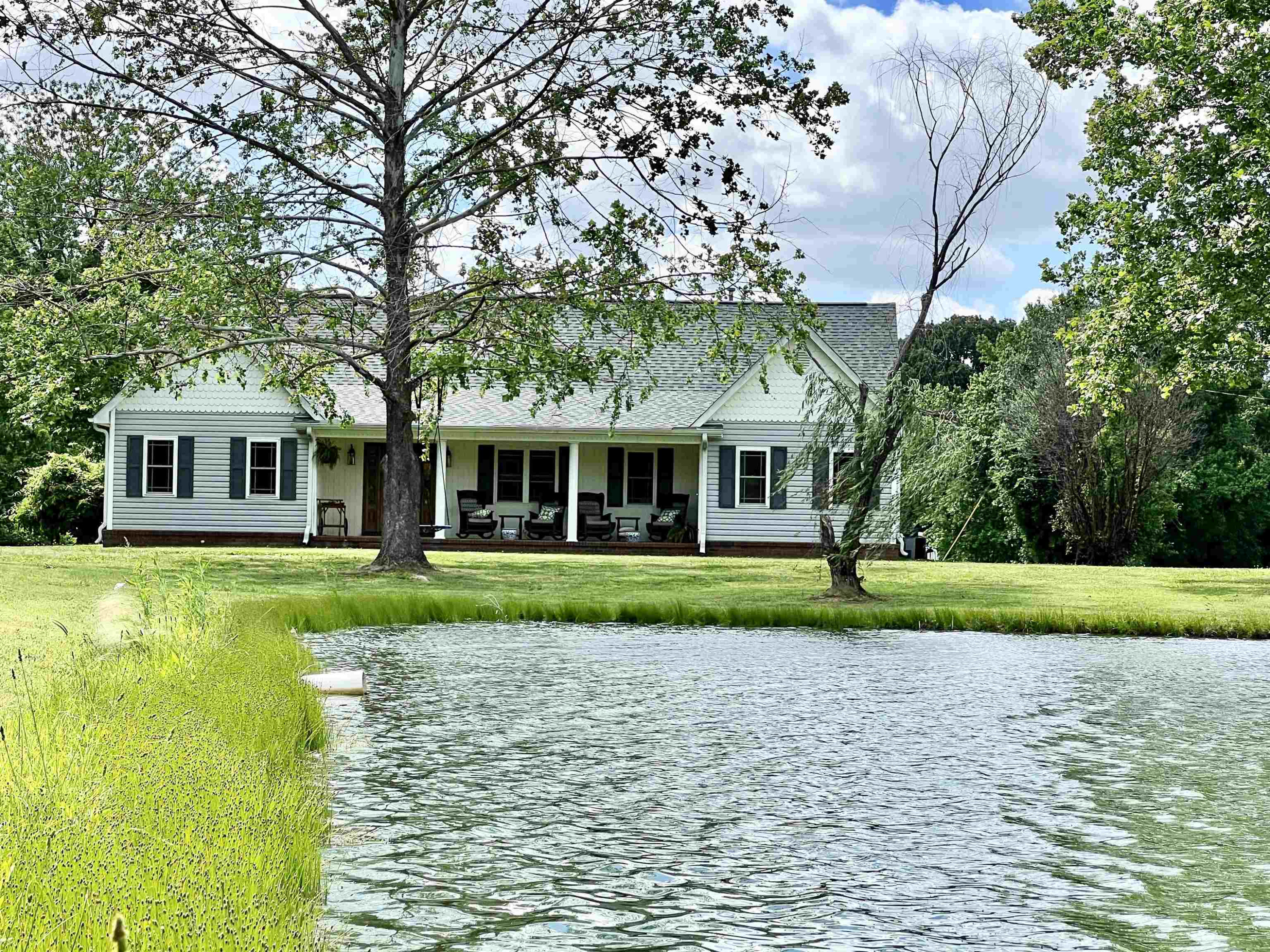 495 Junius Lee Road Ripley, TN 38063 - Photo 2 of 38 a front view of a house with a yard and large trees