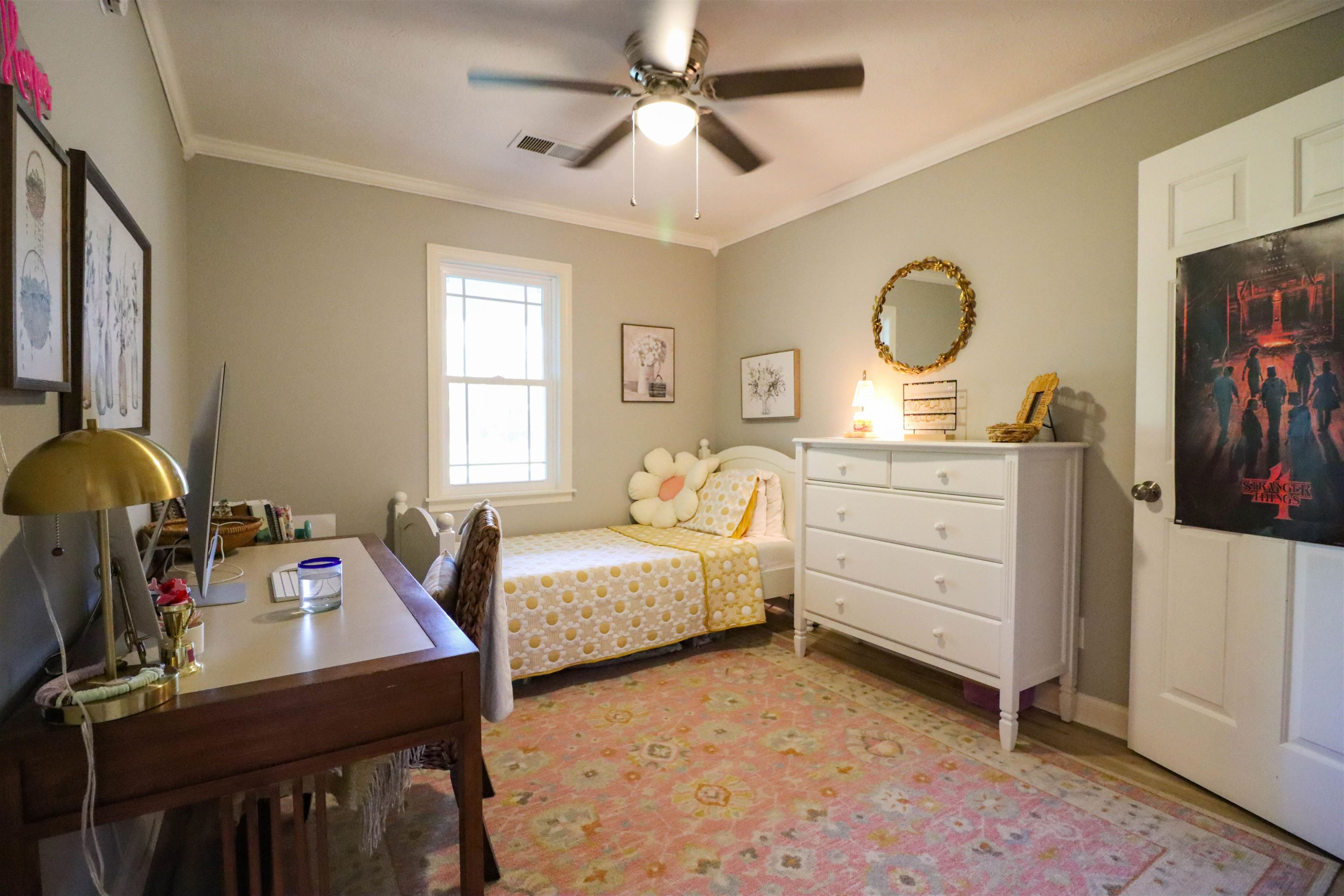 495 Junius Lee Road Ripley, TN 38063 - Photo 30 of 38 a bedroom with a bed and a chandelier