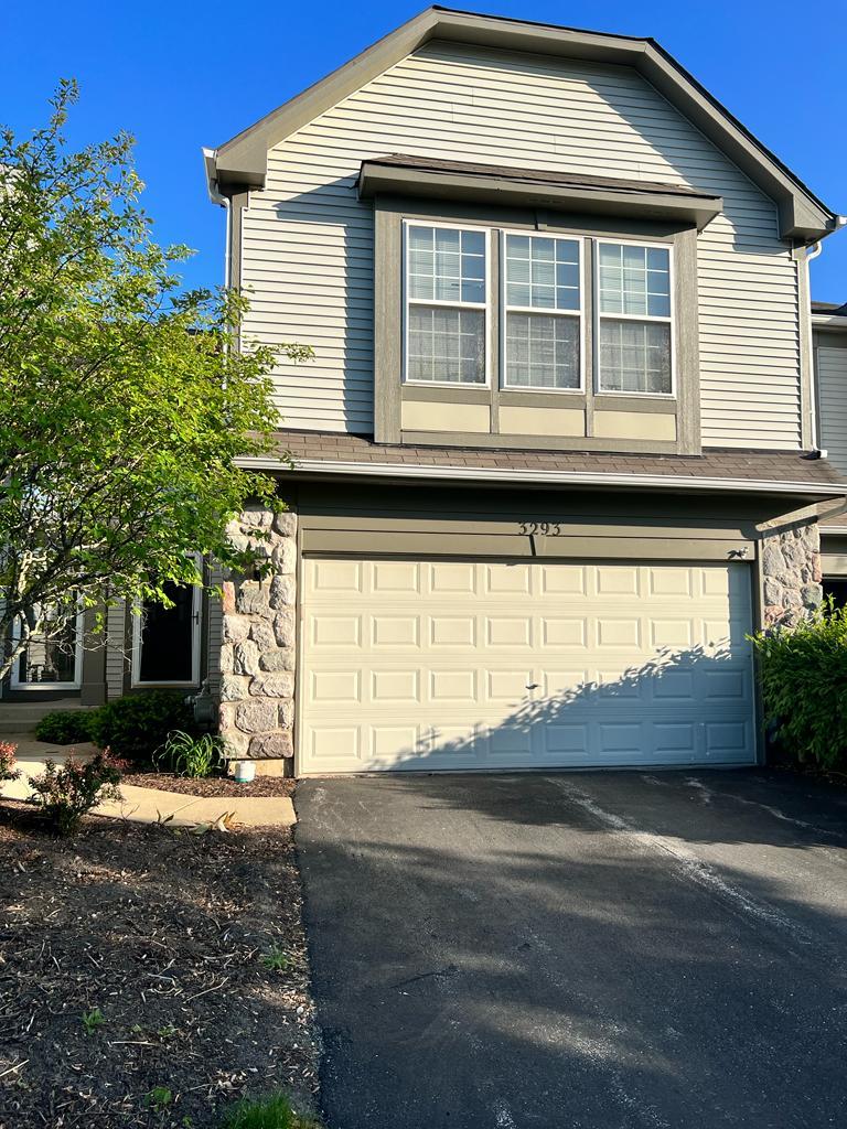 3293 Cremin Lane Aurora, IL 60502 - Photo 1 of 8 a front view of a house with a yard and garage
