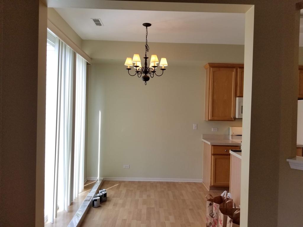 3293 Cremin Lane Aurora, IL 60502 - Photo 6 of 8 a view of a hallway with chandelier and front door
