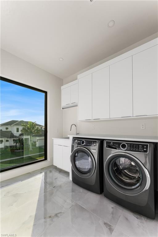159 Dan River Court Marco Island, FL 34145 - Photo 22 of 38 Laundry area featuring cabinet space, washer and dryer, and recessed lighting