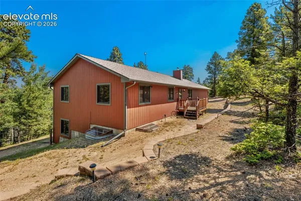 a view of a house with a backyard