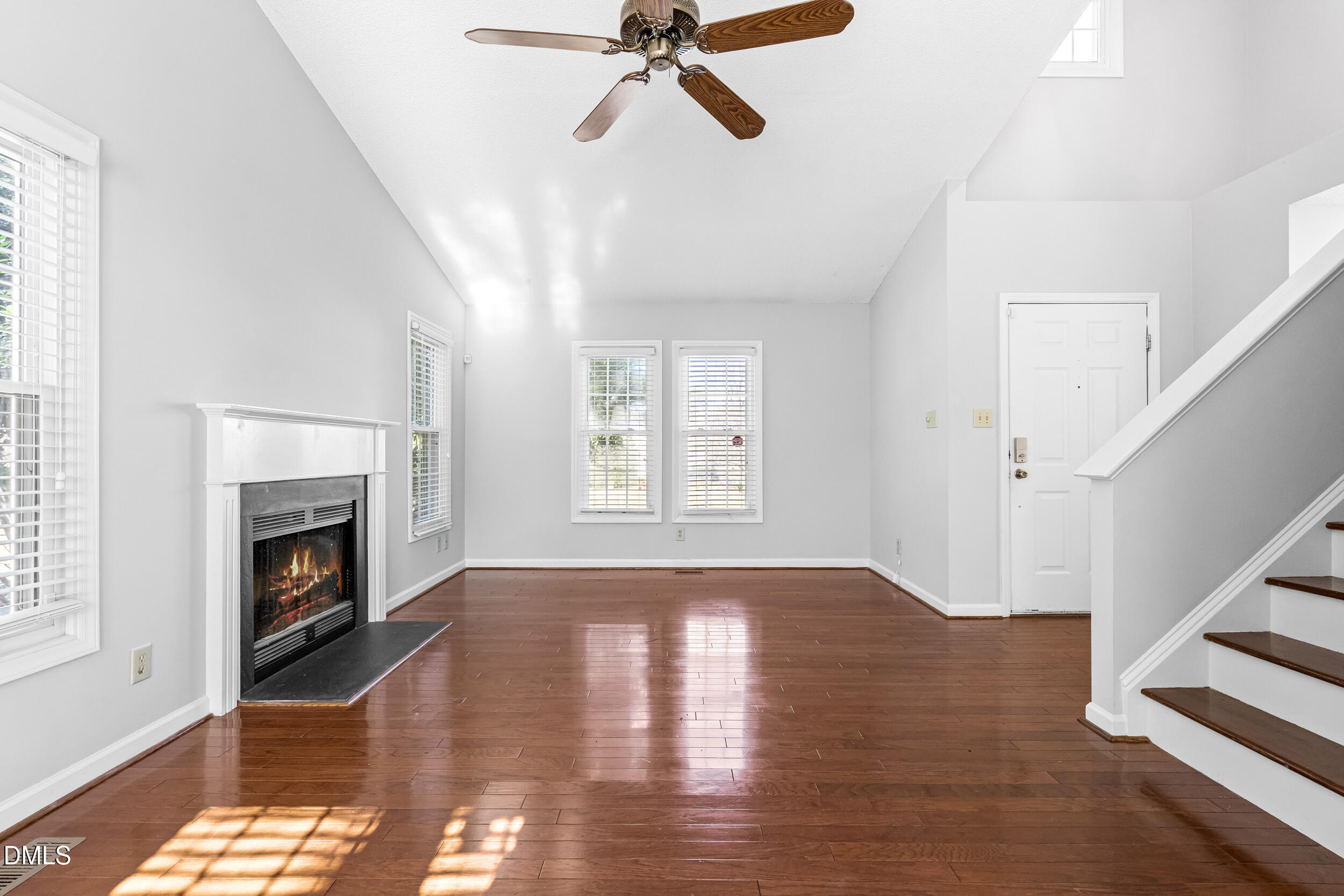 5228 Turf Grass Court Raleigh, NC 27610 - Photo 5 of 34 a view of an empty room with wooden floor fireplace and a window