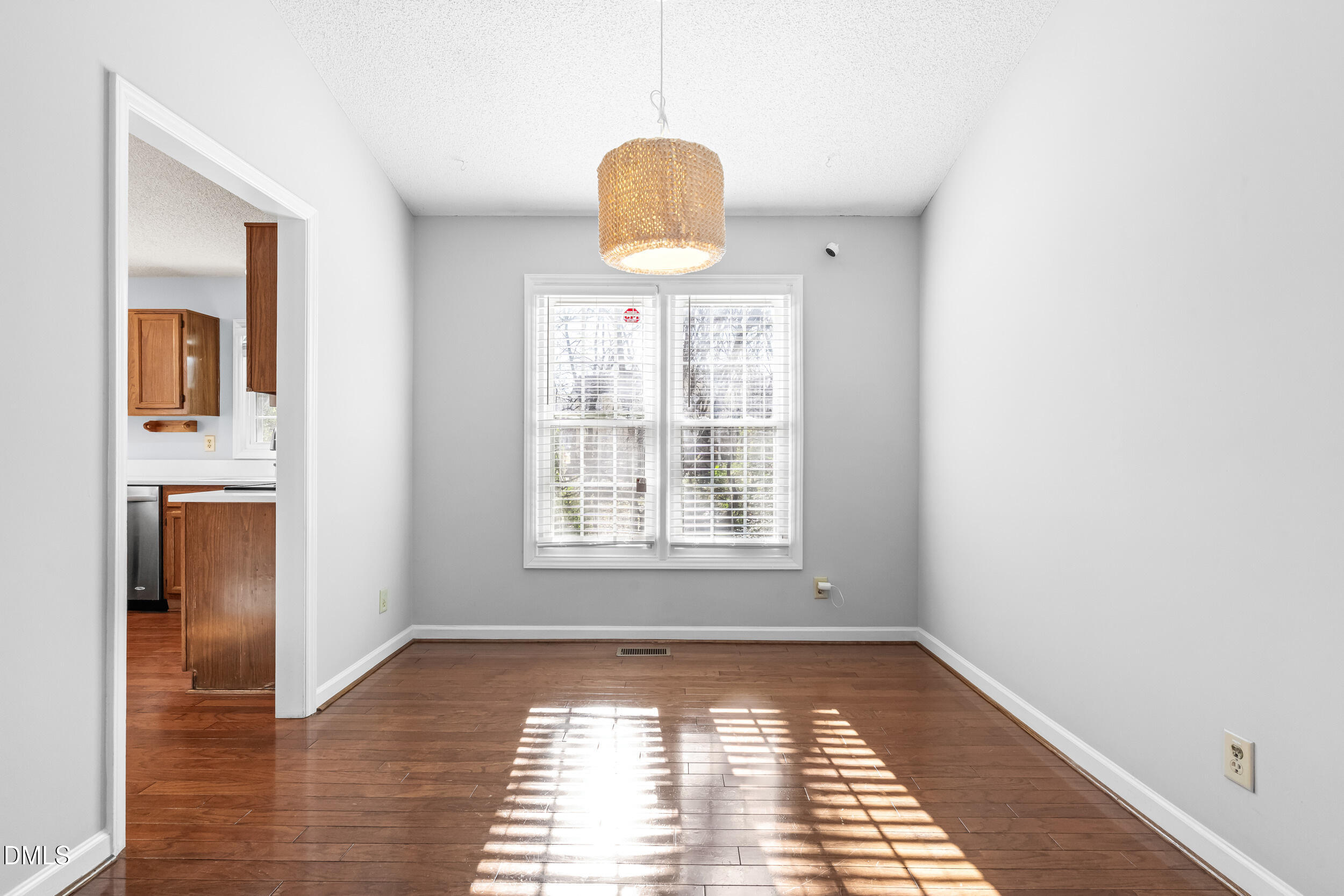 5228 Turf Grass Court Raleigh, NC 27610 - Photo 8 of 34 a view of an empty room with window and wooden floor