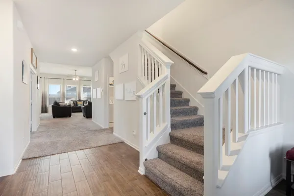 a view of entryway and hall with wooden floor