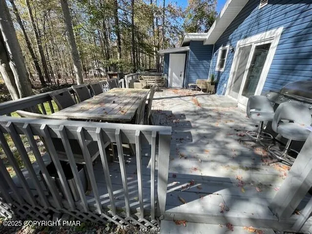 a view of balcony with chairs and wooden fence
