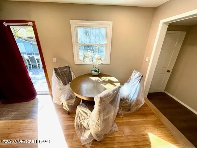 a view of a dining room with furniture and wooden floor