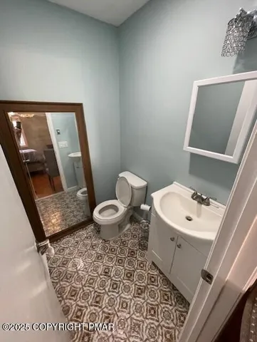 a white toilet sitting next to a bathroom sink