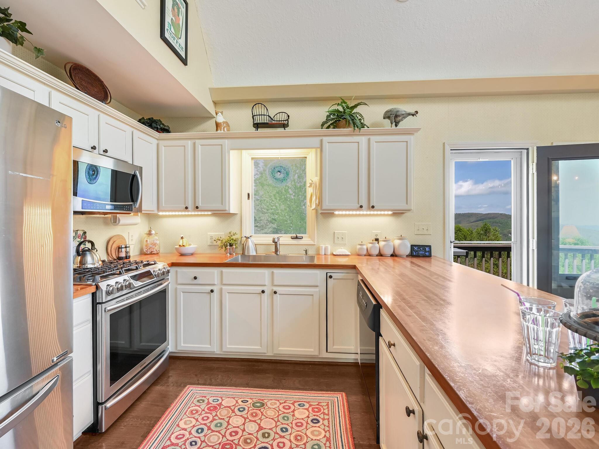 107 Fawns Rest Black Mountain, NC 28711 - Photo 14 of 47 a kitchen with stainless steel appliances granite countertop a sink stove and refrigerator